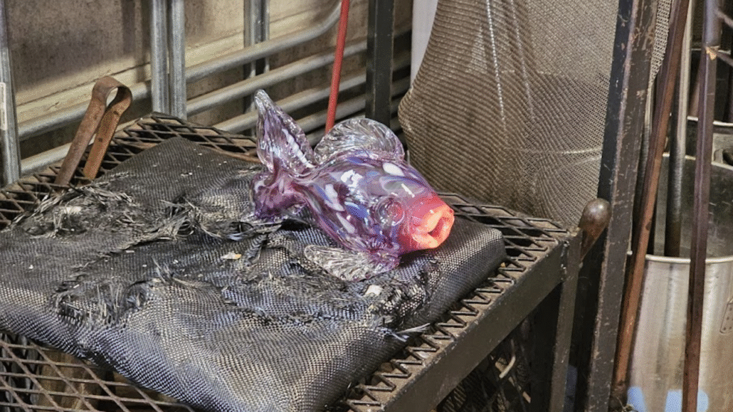 Authentic hand-blown glass piece glowing hot during the glassblowing process at Moana Glass